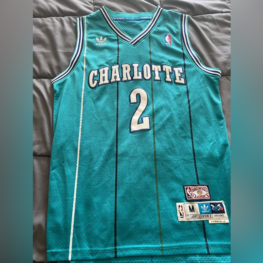 Up for sale is an Adidas Hardwood Classics Larry Johnson Hornets Jersey.